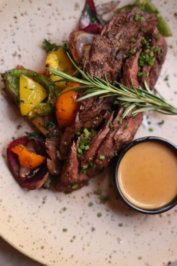 roasted meat with vegetables sprinkled with chives and gravy