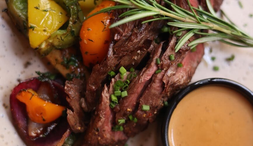 roasted meat with vegetables sprinkled with chives and gravy