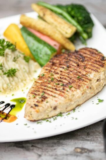 side view delicious grilled fish steak with a vegetable and sau seafood