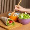 fresh vegetable wrap with vibrant salad bowls