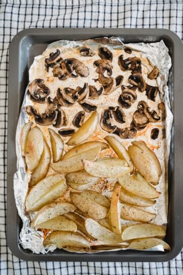 roasted potato wedges and mushrooms on the tray